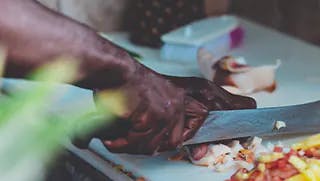 chef chopping onions with a knife